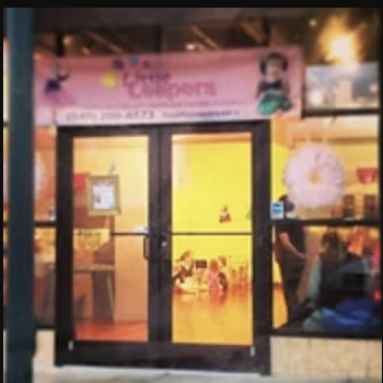 Glass door with a pink sign above, showing a person and text, with reflections and interior visible through the glass.