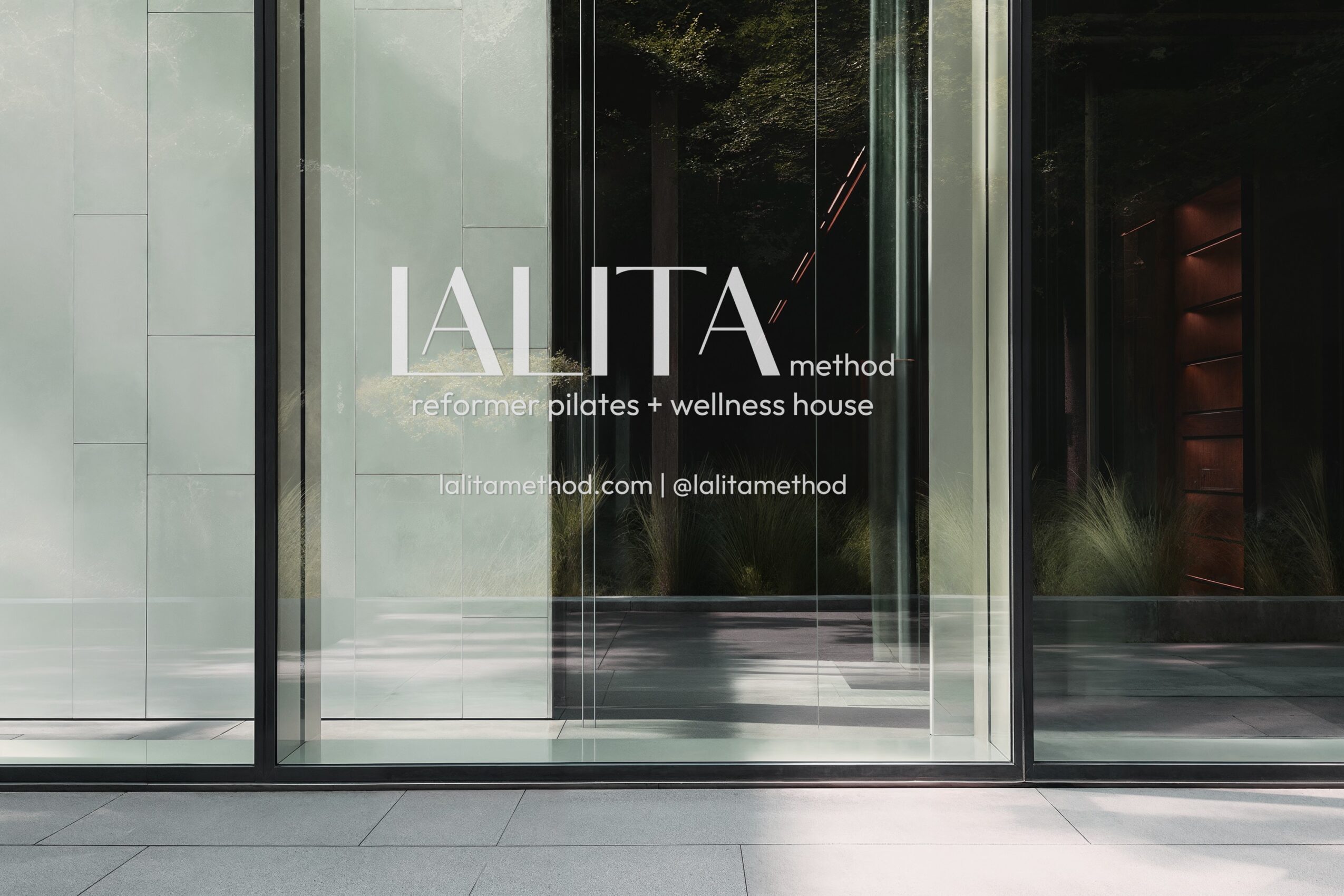 Glass door with the words 'LALITA method' and contact information, reflecting trees and building exterior.
