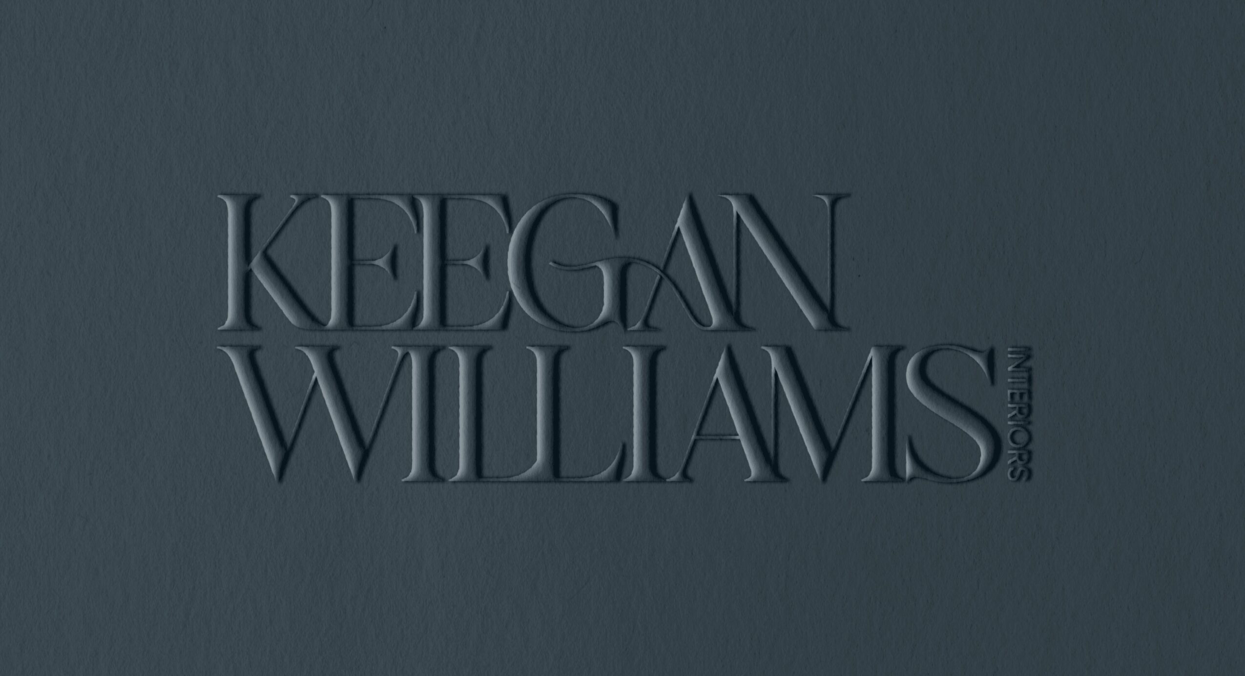 Text reads 'KEEGAN WILLIAMS' embossed on a dark background.