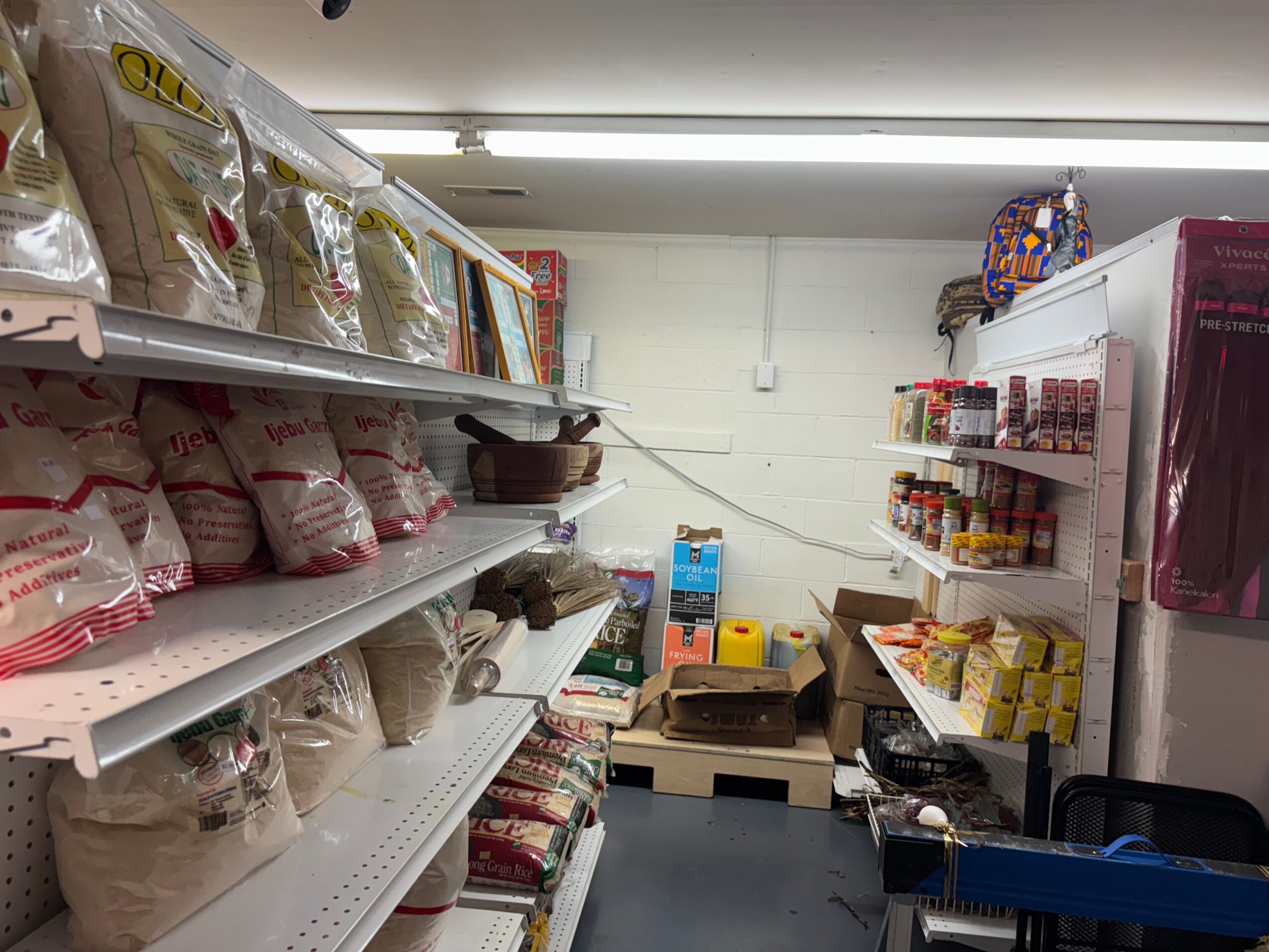 Shelves stocked with bags of flour and baking ingredients in a store aisle.